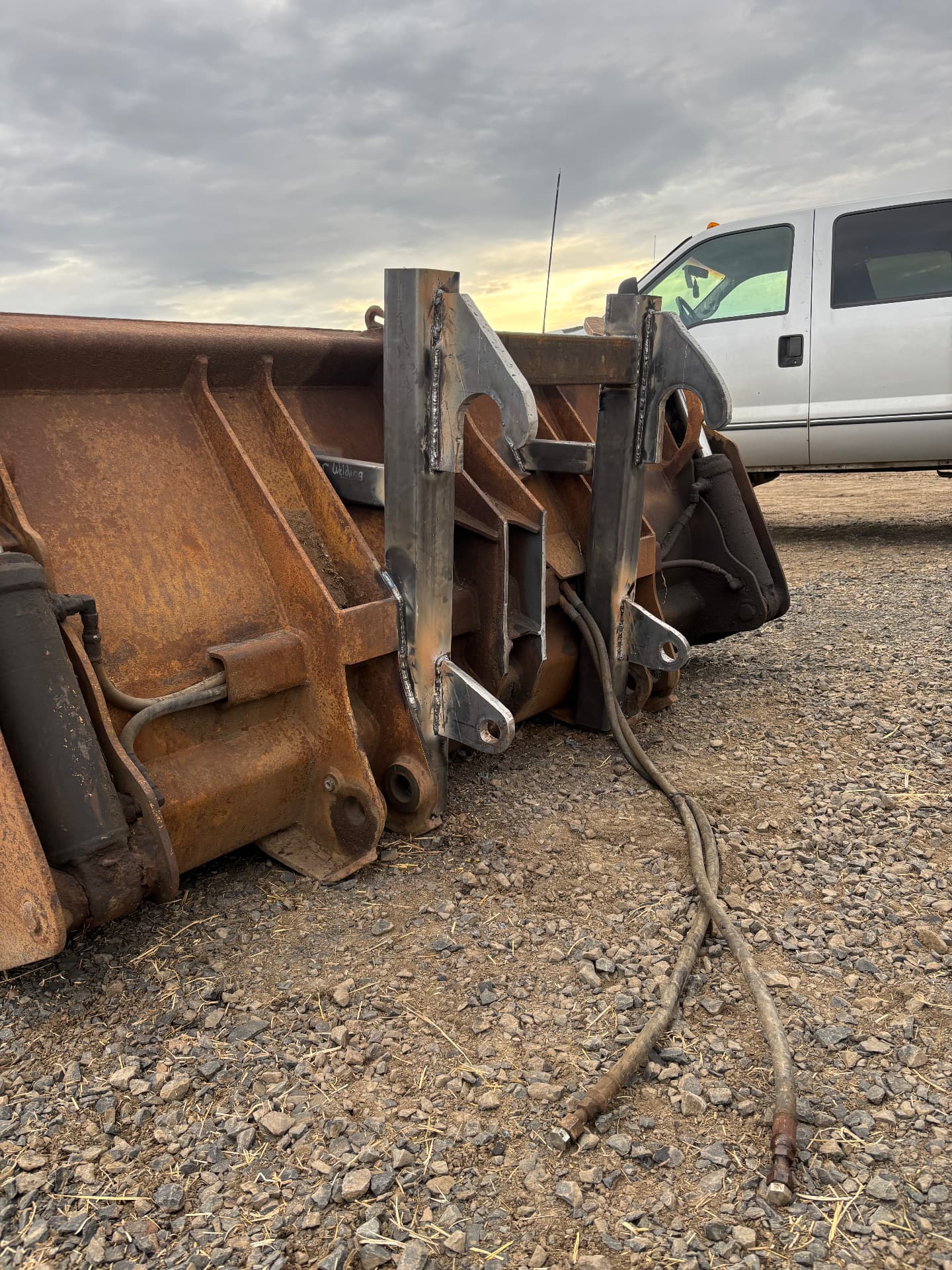Welded bracket assembly on a wheel loader bucket from the side