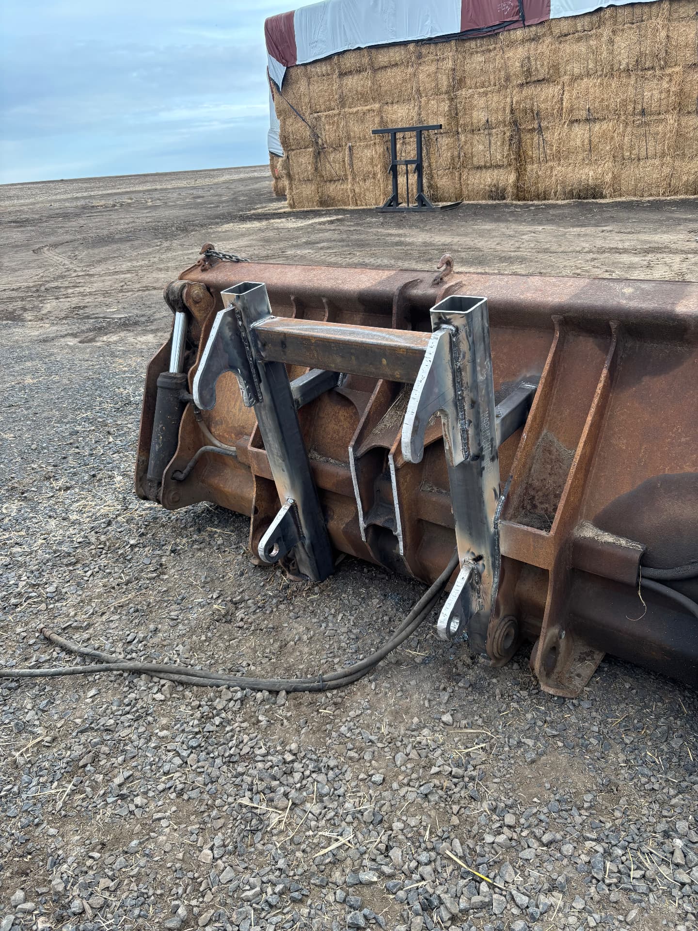 New fabricated steel brackets welded onto a wheel loader bucket