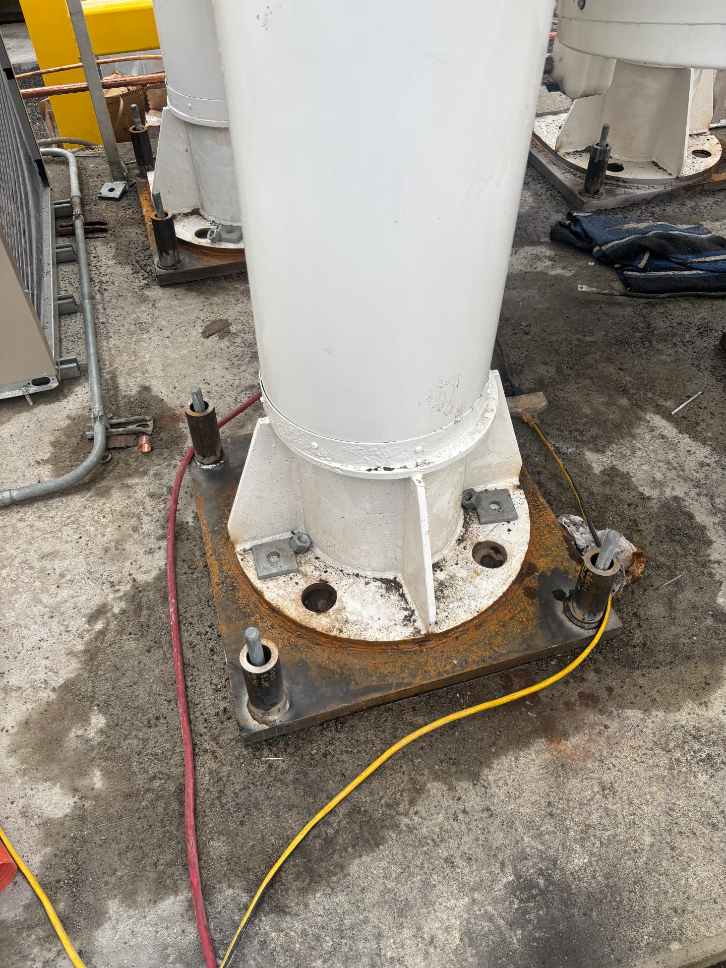 Steel column seated on its base plate with anchor bolts fitted