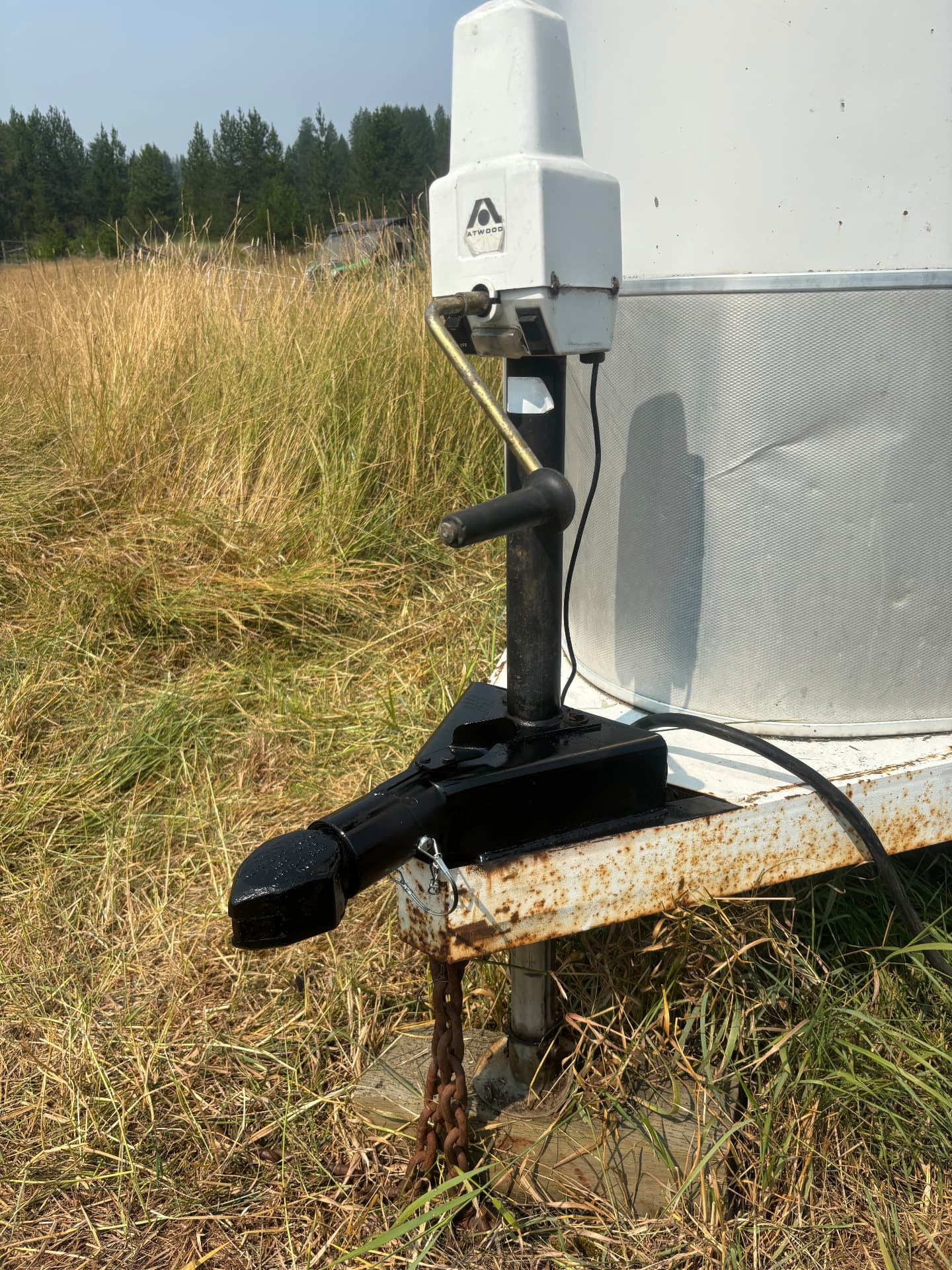 Newly welded and painted black trailer coupler installed on the trailer tongue